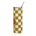 A tall insulated tumbler with a clear lid and glass straw, featuring a mustard yellow and cream checkerboard pattern with a partial dog illustration on the side.