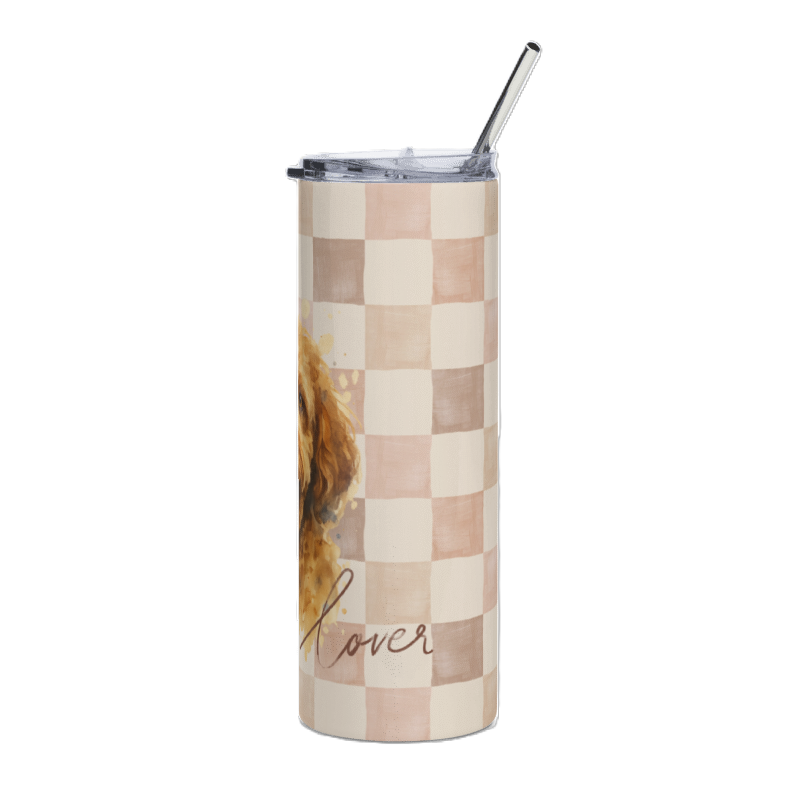 A tall insulated tumbler with a clear lid and metal straw, featuring a beige and blush pink checkerboard pattern, a partial watercolor dog illustration, and the word 'lover' in script near the bottom.