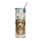 A tall insulated tumbler with a clear lid and metal straw, featuring a printed watercolor-style aussie doodle dog portrait over a pastel check pattern on a white background.