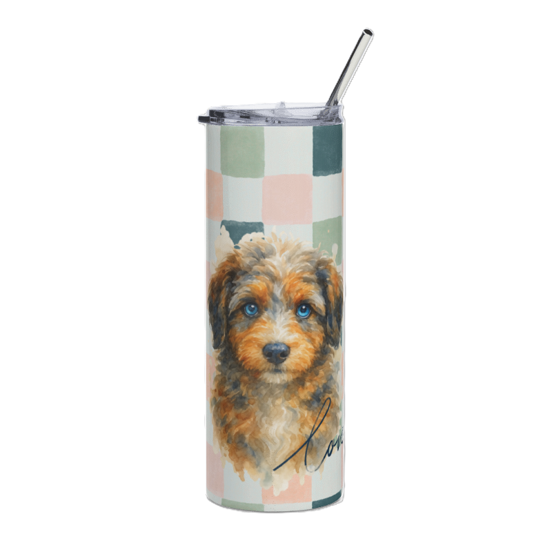 A tall insulated tumbler with a clear lid and metal straw, featuring a printed watercolor-style aussie doodle dog portrait over a pastel check pattern on a white background.