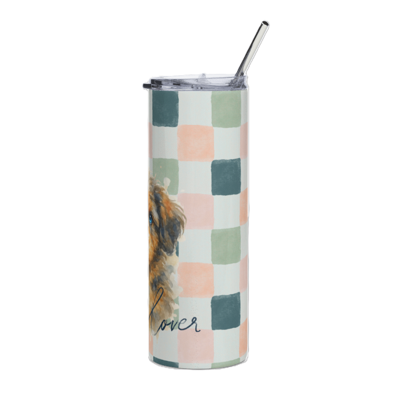 A tall insulated tumbler with a clear lid and metal straw, featuring a pastel checkered pattern in pink, sage green, and teal on a white background, with a partial dog illustration and the word 'lover' printed near the bottom.