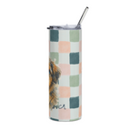 A tall insulated tumbler with a clear lid and metal straw, featuring a pastel checkered pattern in pink, sage green, and teal on a white background, with a partial dog illustration and the word 'lover' printed near the bottom.