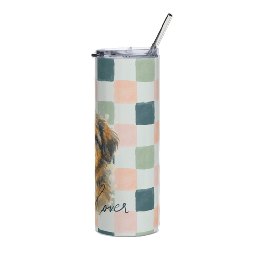 A tall insulated tumbler with a clear lid and metal straw, featuring a pastel checkered pattern in pink, sage green, and teal on a white background, with a partial dog illustration and the word 'lover' printed near the bottom.